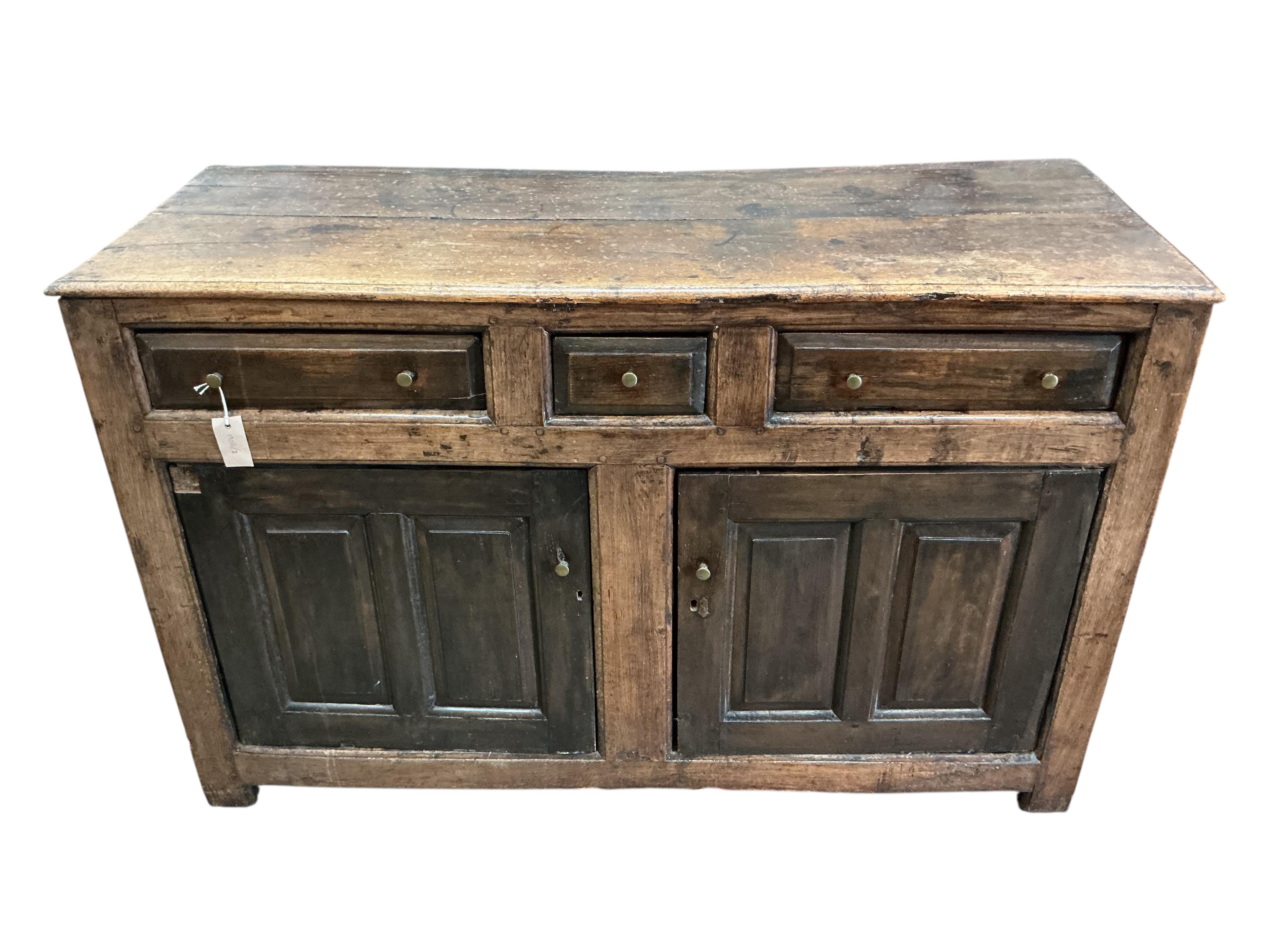 A mid 18th century North Wales oak enclosed dresser base, width 134cm, depth 52cm, height 85cm